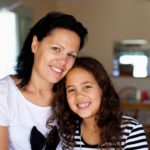 Mum and daughter smiling