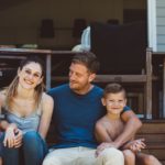 Casual family portrait on the steps of their backyard.