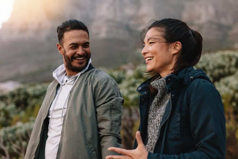 Happy couple walking and talking in the countryside