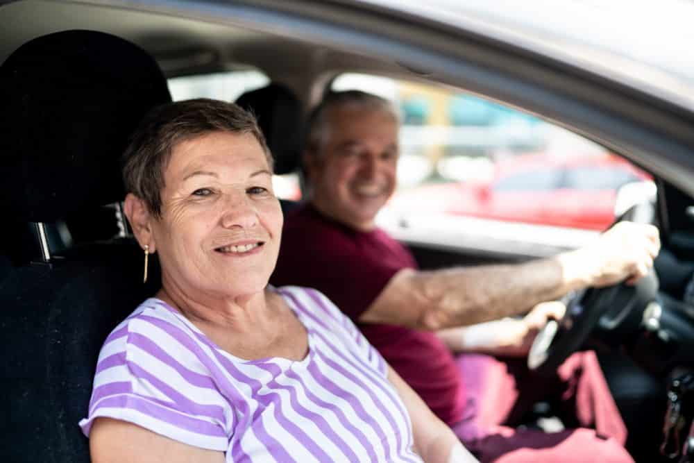 Portrait of senior couple inside a car