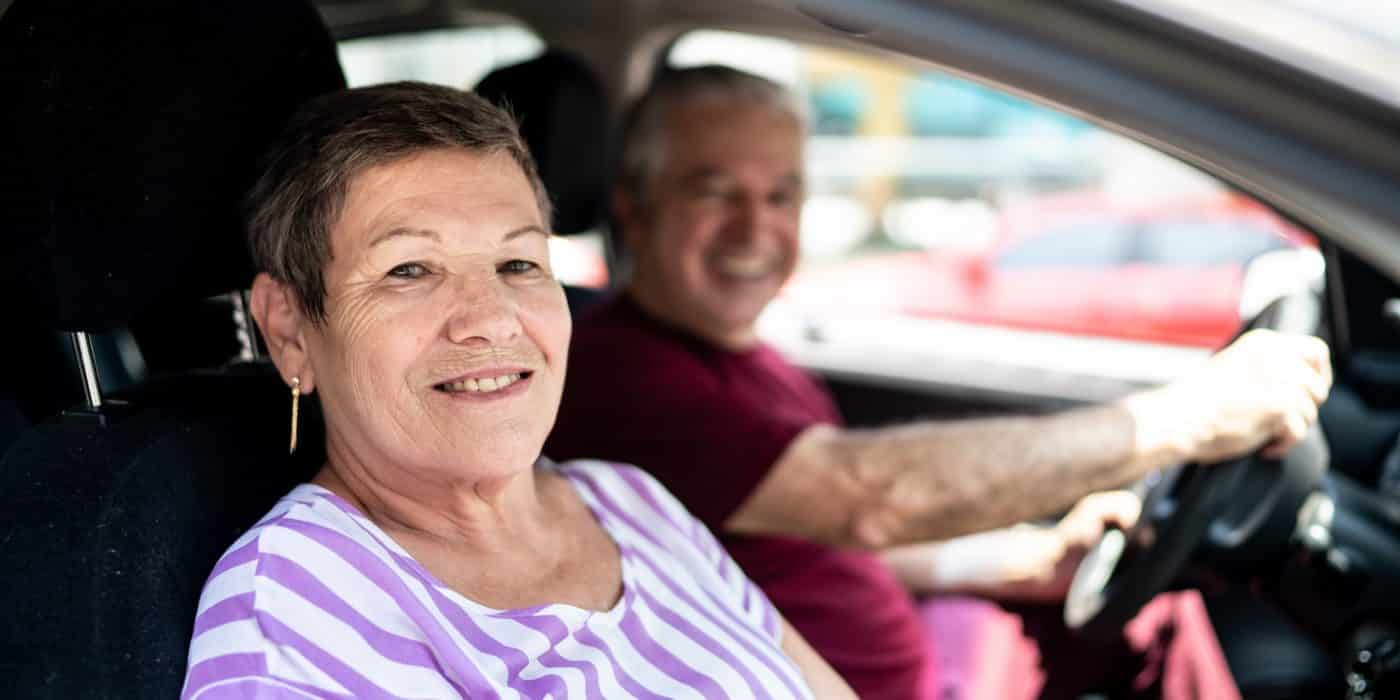 Portrait of senior couple inside a car