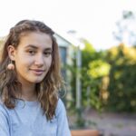 Portrait of a Happy Teenage Maori Girl Smiling in the Backyard