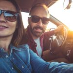 Photo of the couple traveling in the car taking selfie