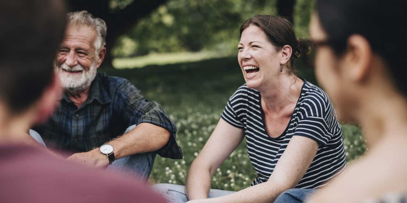 Cheerful woman in the park with her friends