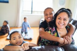 Maori mother spending quality time with kids at home in Auckland, New Zealand.