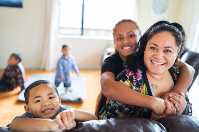 Maori mother spending quality time with kids at home in Auckland, New Zealand.