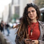 Hippie Young Woman Using her Smartphone in the City