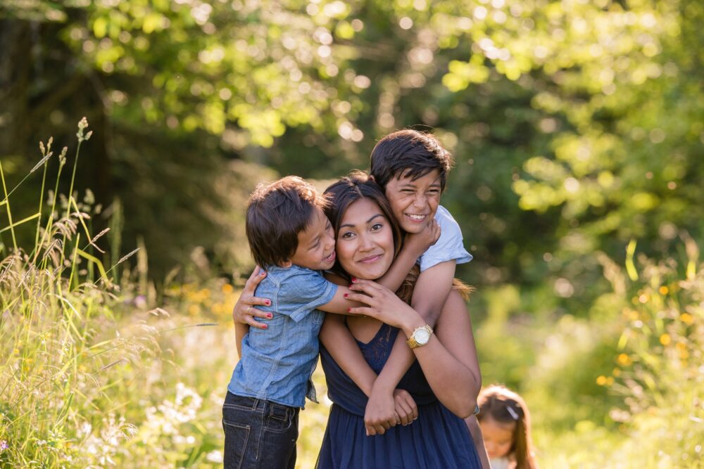 a young mother and her children in a summer park